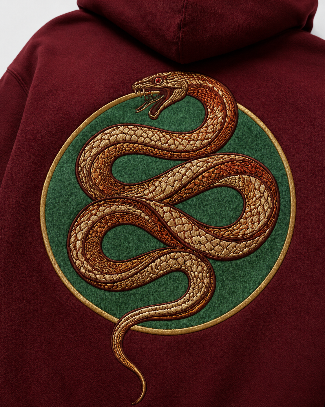Emerald Serpent Coil Hoodie by Sukaizen in burgundy red with snake fang chest embroidery and large serpent back design